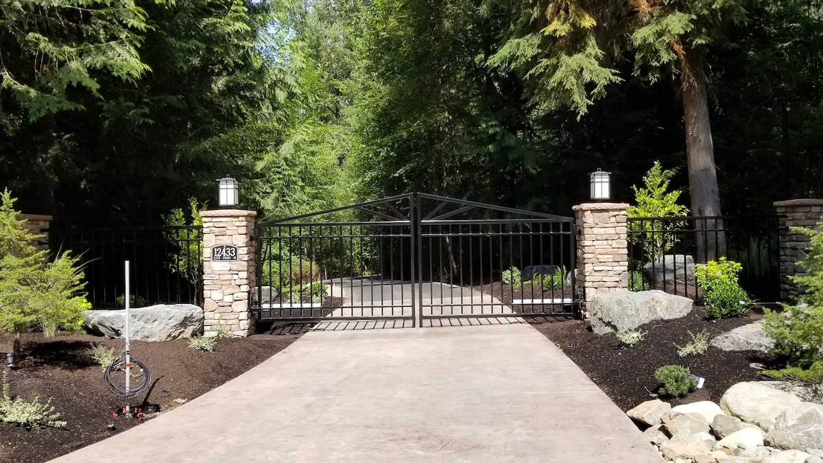 Closed, Woodinville Steel Driveway Gate, Stamped Concrete Drive, With Stone-Faced Pillars