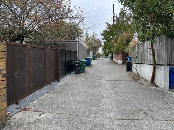 Corten steel alley gate in Queen Anne Seattle secures the family home and car.