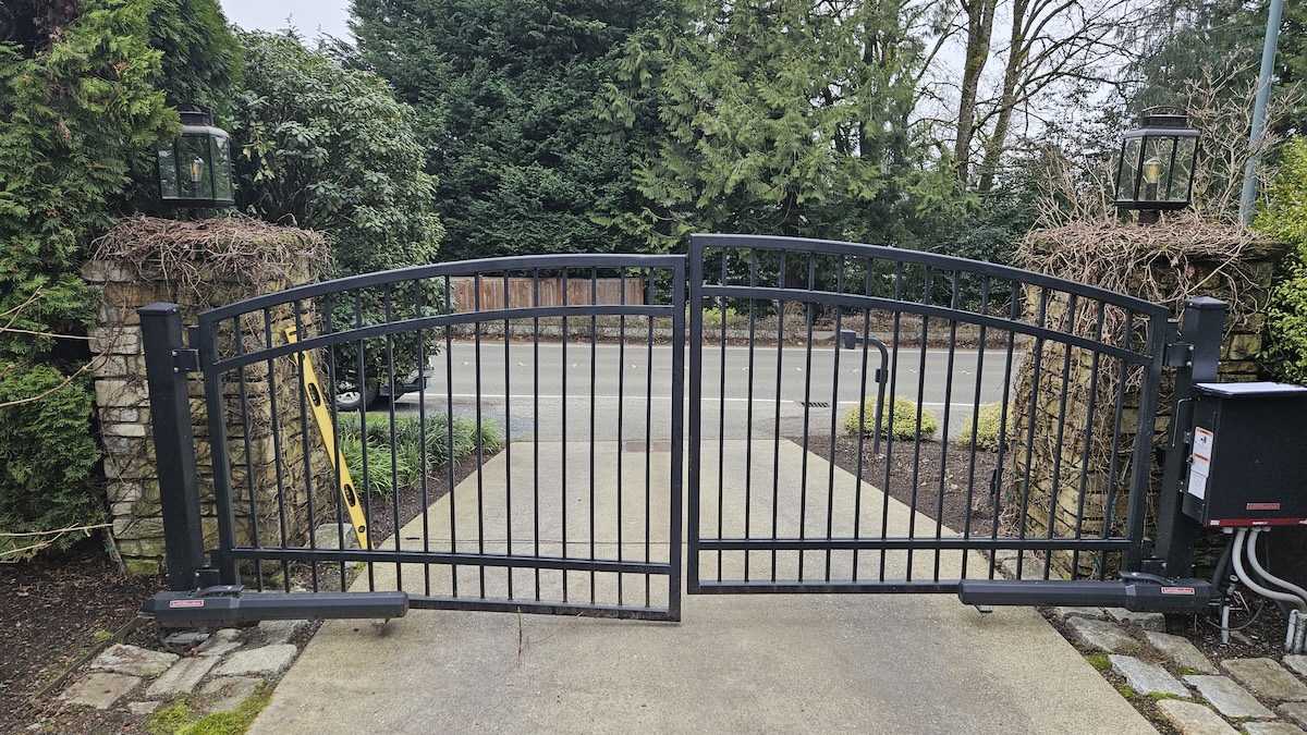 Steel Gate Post And Double-Swing Gate Panel Damaged By A Wind Storm Falling Tree Branch